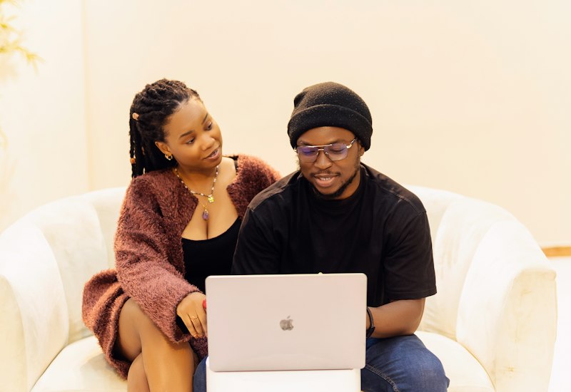 Couple reviewing household accounts on a laptop